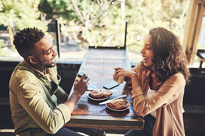 Buy stock photo Shot of a young couple having pastries at a coffee shop