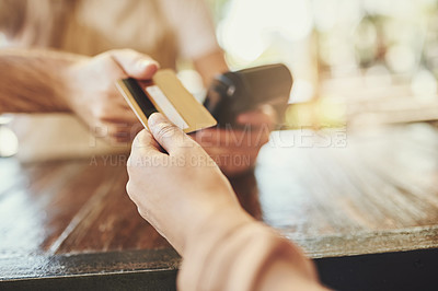 Buy stock photo Cropped shot of a customer making a card payment in a coffee shop