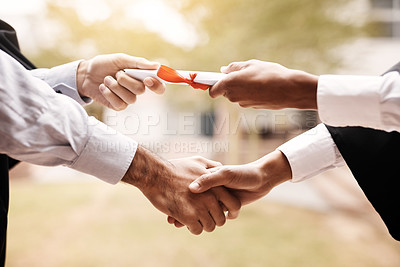 Buy stock photo Cropped shot of a unrecognizable student receiving a diploma on graduation day