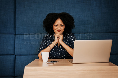 Buy stock photo Portrait of a cheerful young female designer working on her laptop at the office during the day