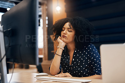 Buy stock photo Shot of a young tired looking female designer falling asleep behind her computer at the office during the day