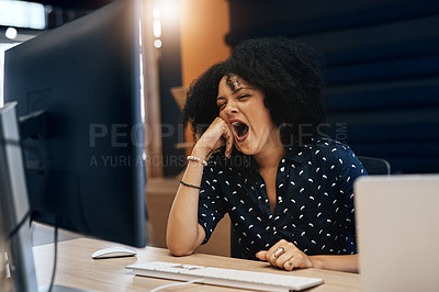 Buy stock photo Shot of a young tired looking female designer falling asleep behind her computer at the office during the day