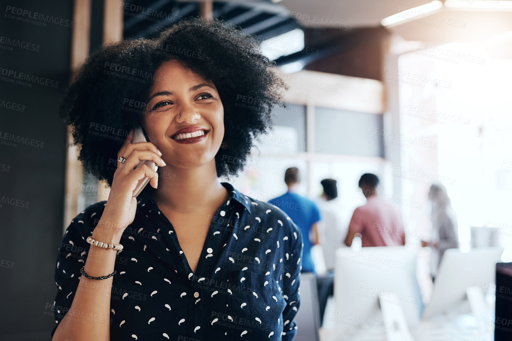 Buy stock photo Shot of an attractive young female designer taking a phone call in the office