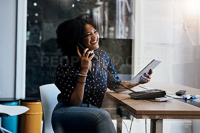 Buy stock photo Shot of a young female designer making a phone call while holding a digital tablet at her office desk