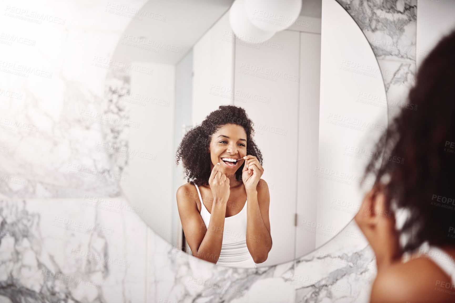 Buy stock photo Black woman, mirror and floss teeth in bathroom for wellness with hygiene, smile and good breath. Happy girl, reflection and cleaning mouth in home for bacteria, dental health or self care as routine