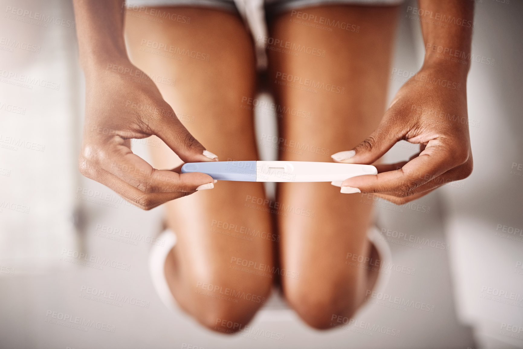 Buy stock photo Hands, healthcare and closeup of a woman with a pregnancy test in the bathroom of her home. Maternity, motherhood and zoom of female person with pregnant stick device for announcement in modern house