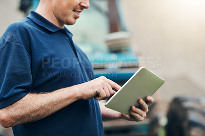 Buy stock photo Farmer, man and hand with tablet by tractor for agriculture, website and research on industry. Farming, planning and male person with technology for production, information and reading weather update