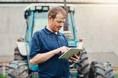 Buy stock photo Agriculture, farming and man with tablet by tractor for production, schedule and research on industry. Farmer, internet and male person with tech for weather, information and reading online update