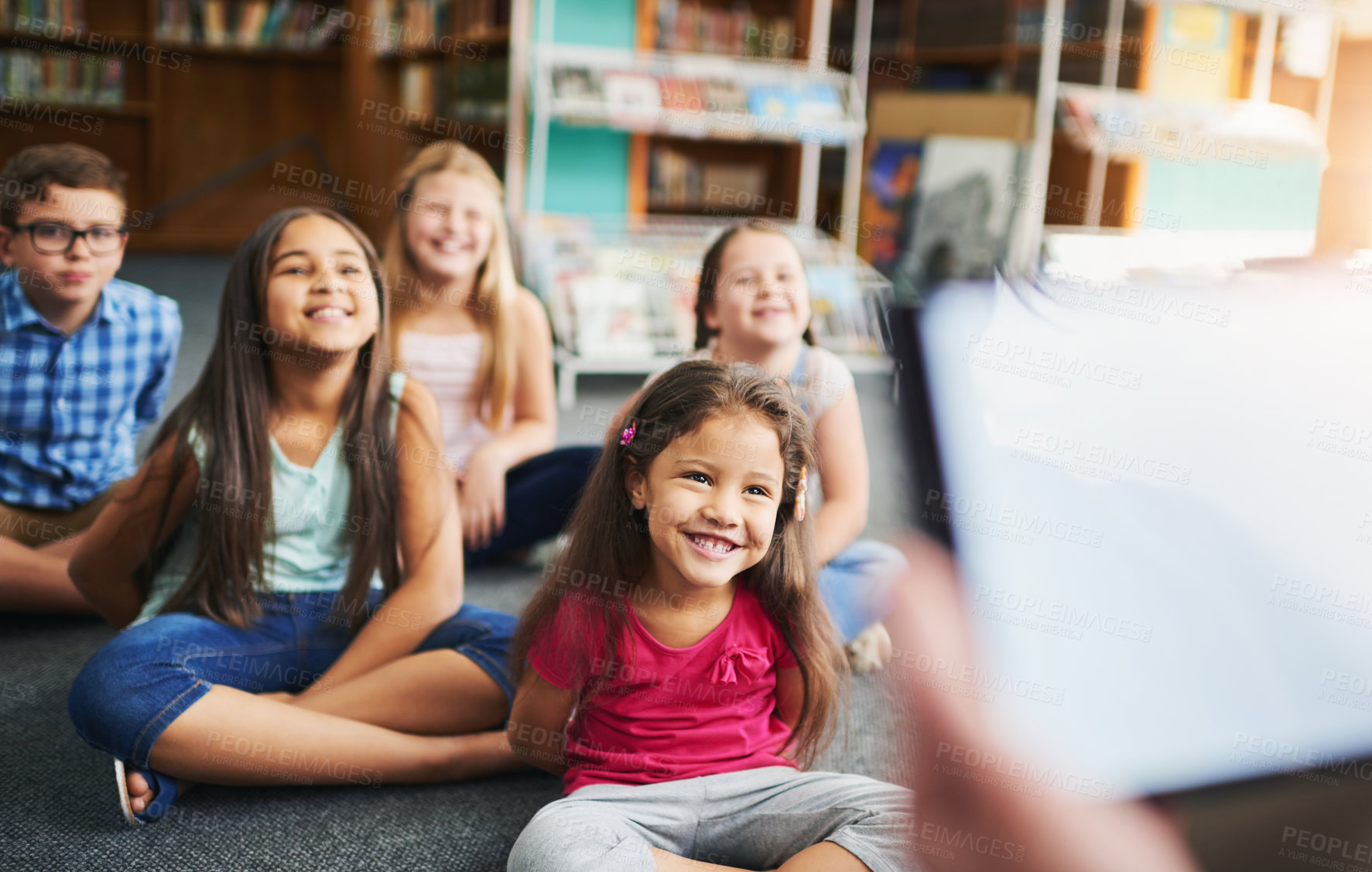 Buy stock photo Happy children, teacher and reading with tablet for ebook, future learning or new generation in development at library. Young, group or kindergarten kids with smile for online novel or story telling