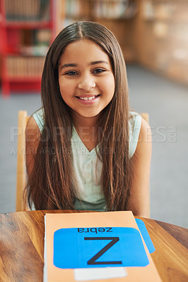 Buy stock photo Girl, child and portrait in library with books, happy and alphabet for education, development and progress. Kid, smile and folder for notes, language and scholarship for studying at school in Mexico