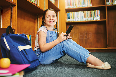 Buy stock photo Library, portrait and happy kid learning on tablet at school for knowledge in kindergarten. Bookshelf, student and girl studying on tech for english test, course and educational game on floor in Uk