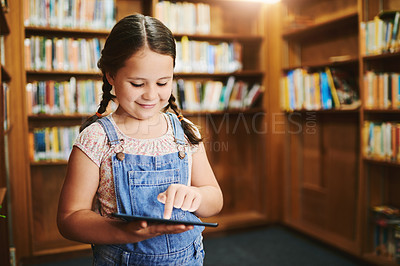 Buy stock photo Library, child and learning on tablet for reading knowledge, ebook or online quiz in kindergarten. Bookshelf, student or happy girl study on tech for english, app or play educational game at school