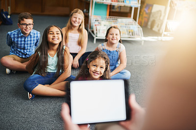 Buy stock photo Happy children, teacher and quiz with tablet screen in library for ebook, listening test or exam on story. Young, group or kindergarten kids with smile for technology, future learning or youth skills