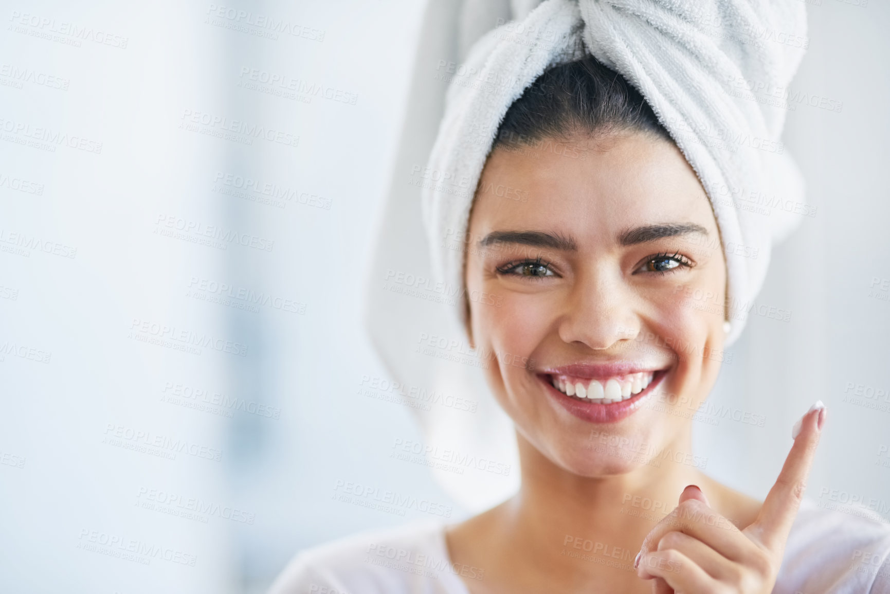 Buy stock photo Beauty, moisturizer and portrait of excited woman in bathroom of home for morning skincare routine. Cream, face and finger with happy person in towel at apartment for cosmetics or dermatology