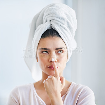 Buy stock photo Beauty, face and moisturizer with woman thinking in bathroom of home for morning skincare routine. Cream, finger and nose with person in towel at apartment for cosmetics or dermatology ideas