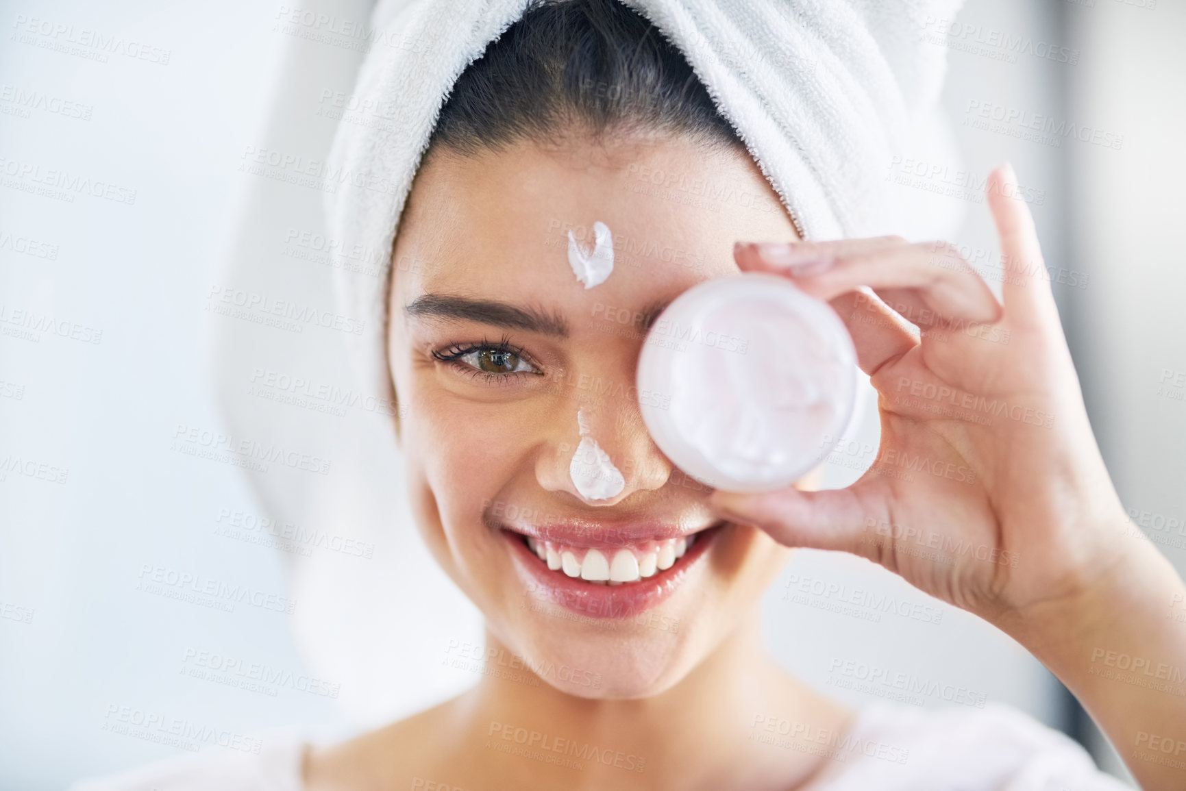 Buy stock photo Beauty, portrait and product with happy woman in bathroom of home for morning skincare routine. Cream, lotion or moisturizer with face of person in towel at apartment for cosmetics or dermatology