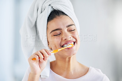 Buy stock photo Woman, towel and smile with brushing teeth in home for dental hygiene, cleaning and morning routine. Toothbrush, happy and person with satisfaction for fresh breath, health and oral care in bathroom