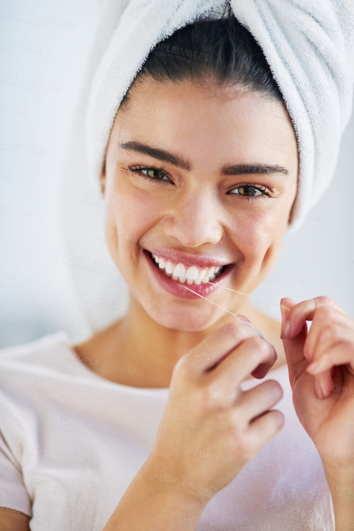 Buy stock photo Female person, flossing and portrait with oral hygiene, cleaning teeth or dental care in home. Woman, morning routine and wellness for healthy mouth, gums or fresh breath in bathroom with towel in UK