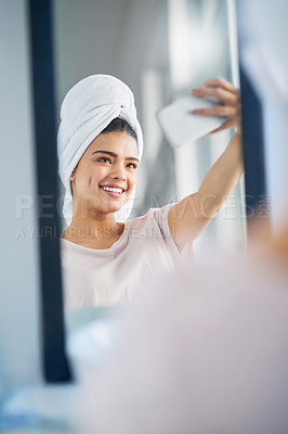 Buy stock photo Shot of a beautiful young woman taking selfies in the bathroom at home