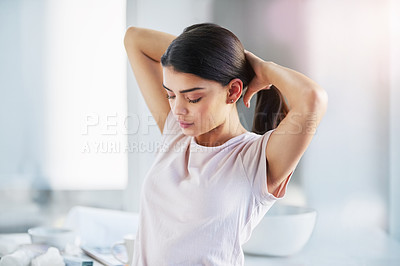 Buy stock photo Shot of a beautiful young woman styling her hair in the bathroom at home