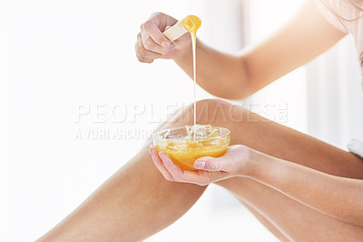 Buy stock photo Closeup shot of an unrecognizable woman waxing her legs in the bathroom at home