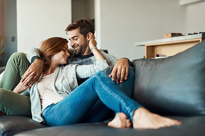 Buy stock photo Couple, smile and relax on sofa in house for comfort, love and bonding time together with trust and care. Man, woman and holding hands in living room for connection, peace and support on weekend 