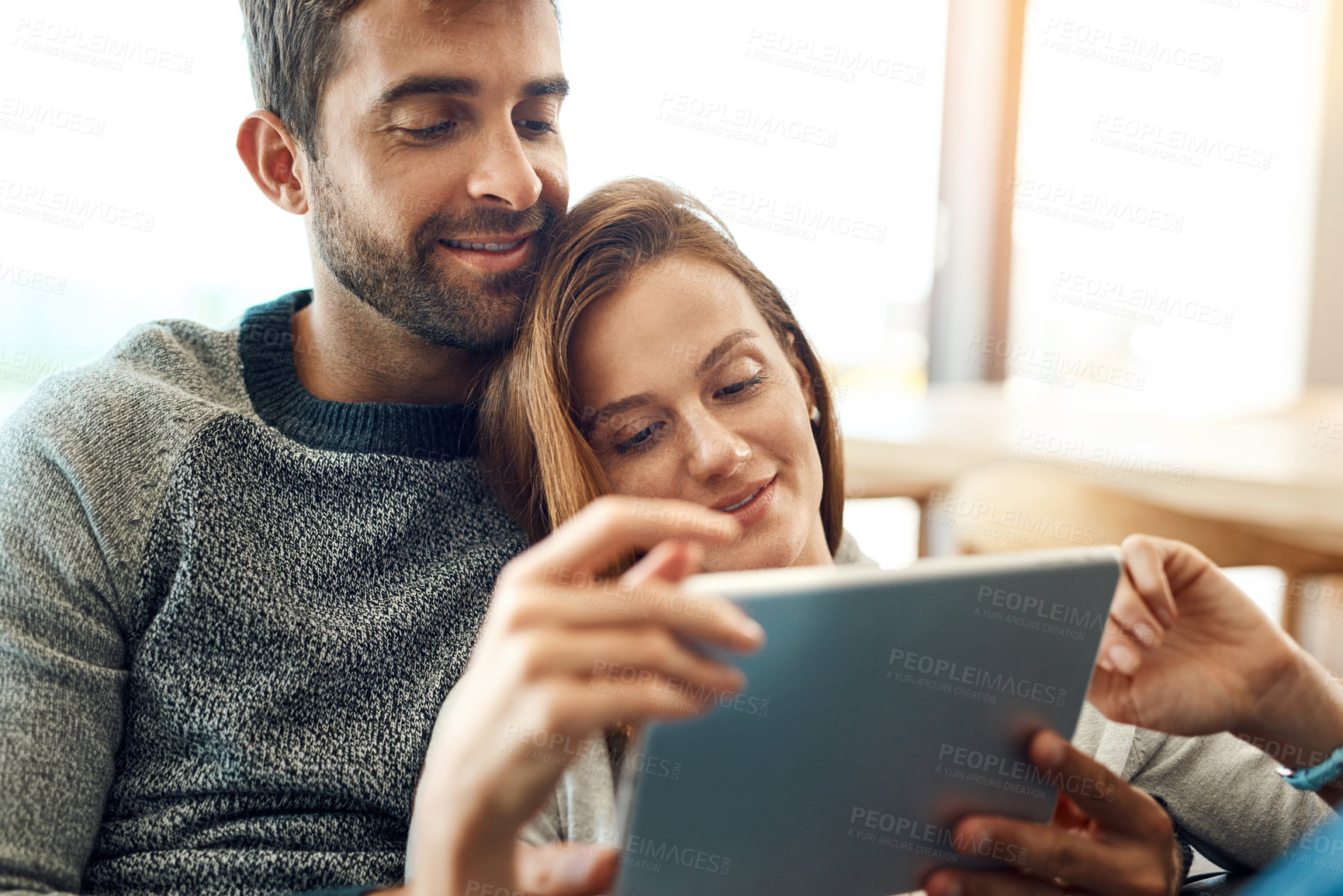 Buy stock photo Happy, couple and hug with tablet and web app subscription for streaming, movie selection or tv choice. Smile, man and woman with tech and love embrace on couch for bonding, search and scroll at home