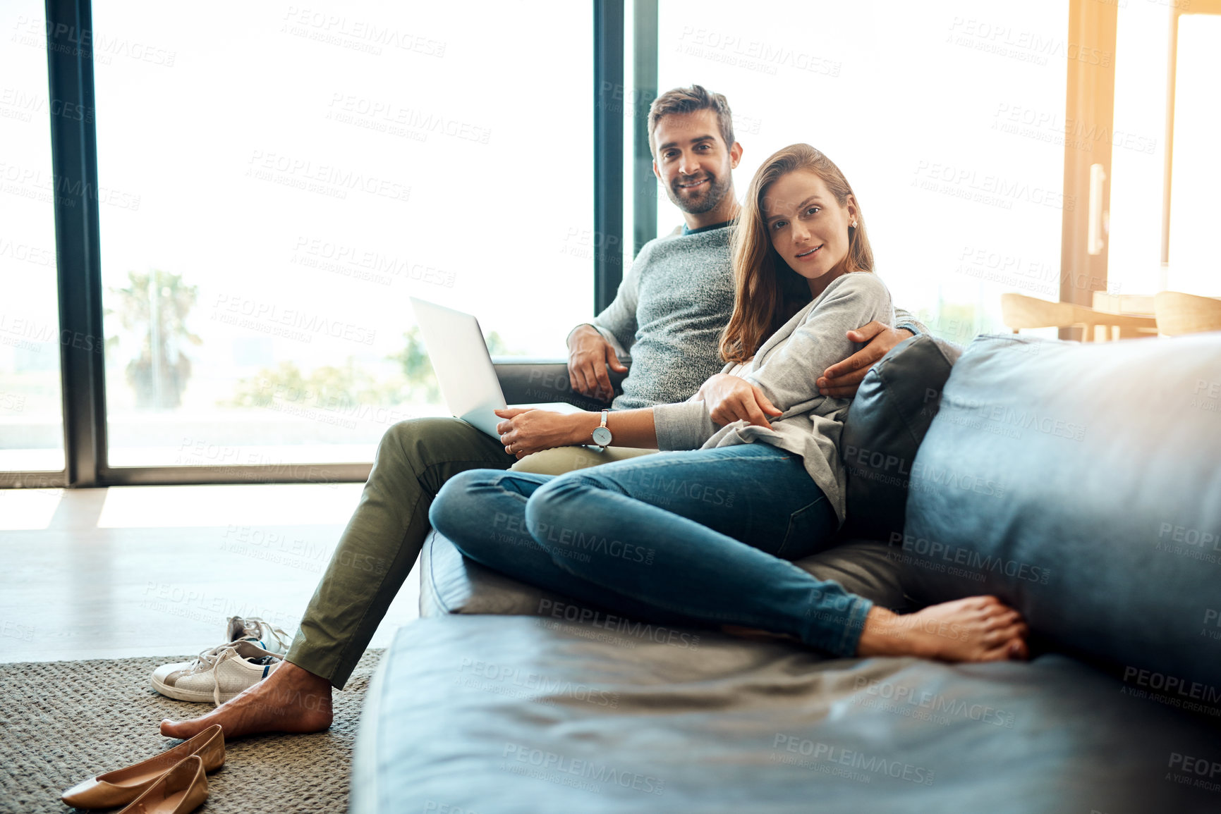 Buy stock photo Portrait, happy couple and laptop in living room for relax, support nad connection for love together. Man, woman and smile by computer in home for social media, news and streaming on website on sofa