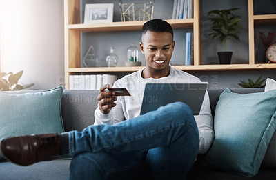 Buy stock photo Ecommerce, black man bank card and laptop in living room on sofa at his home. Online shopping, technology and happy African male person on couch with internet banking with digital device at house