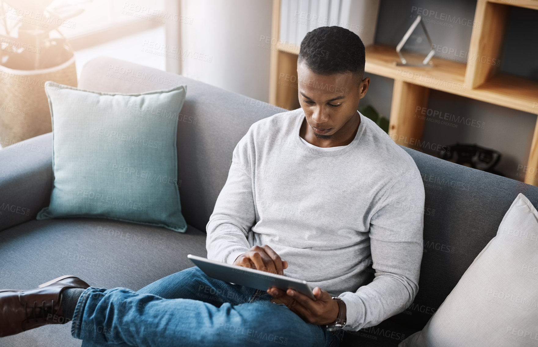 Buy stock photo Relax, tablet and man on sofa from above with social media post, email or streaming video on subscription service. Networking, internet and connection, male surfing online shopping website on couch.