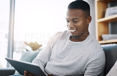 Buy stock photo Living room, tablet and happy man on couch browsing social media meme, email or streaming video subscription service. Happiness, internet and guy networking with smile on face reading website on sofa