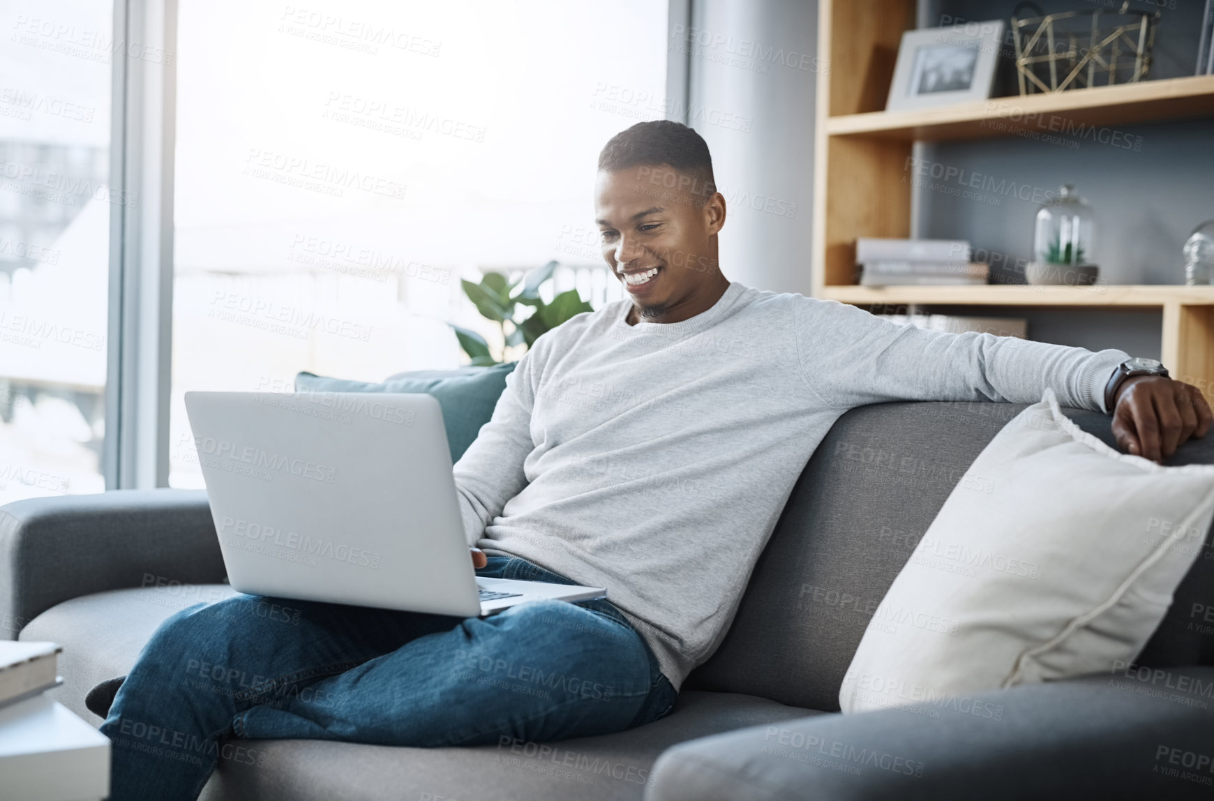 Buy stock photo Black man relax on couch with laptop, streaming online in living room and subscription service with internet. Technology, connectivity and happy male person chill at home watching tv show or film