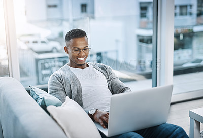 Buy stock photo Black man, couch and home with laptop for relax, watching movies and streaming app. African male person, tech and living room in apartment with social media for day off, online subscription and rest