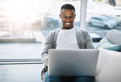 Buy stock photo Laptop, man and working on home sofa or remote learning, elearning or online class, internet and email communication. African male, happy on computer and study, research and work in living room 