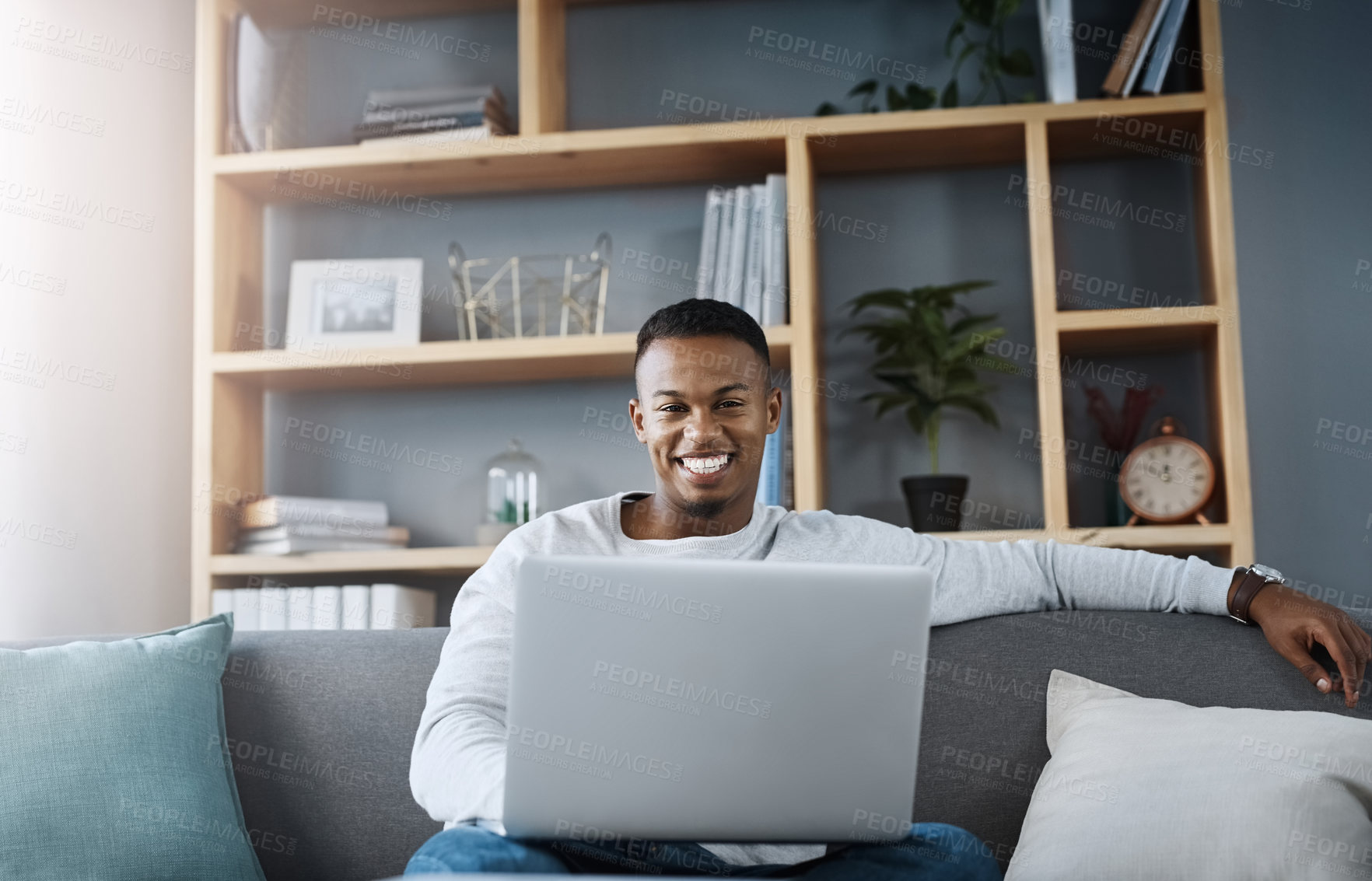 Buy stock photo Man, portrait and laptop in home on sofa, networking and social media for online streaming in living room. Happy, research and technology on website, remote work and internet blog in apartment