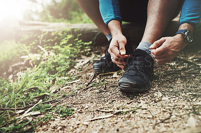 Buy stock photo Tying laces, fitness and hands in nature to start walking, adventure or trekking for exercise. Shoes, sports and feet of a man getting ready for cardio, training or a walk for a workout in a park