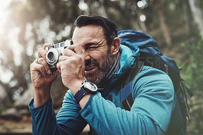 Buy stock photo Nature, camera and man in forest for photography, travel and hiking, journey or memory. Jungle, backpack and mature wildlife photographer with digital lens for adventure, explore or outdoor discovery