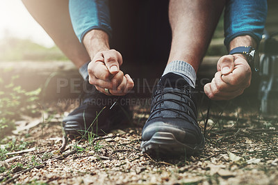 Buy stock photo Tying laces, hiking and hands in nature to start walking, adventure or trekking for exercise. Shoes, sports and feet of a man getting ready for cardio, training or a walk for fitness in a park
