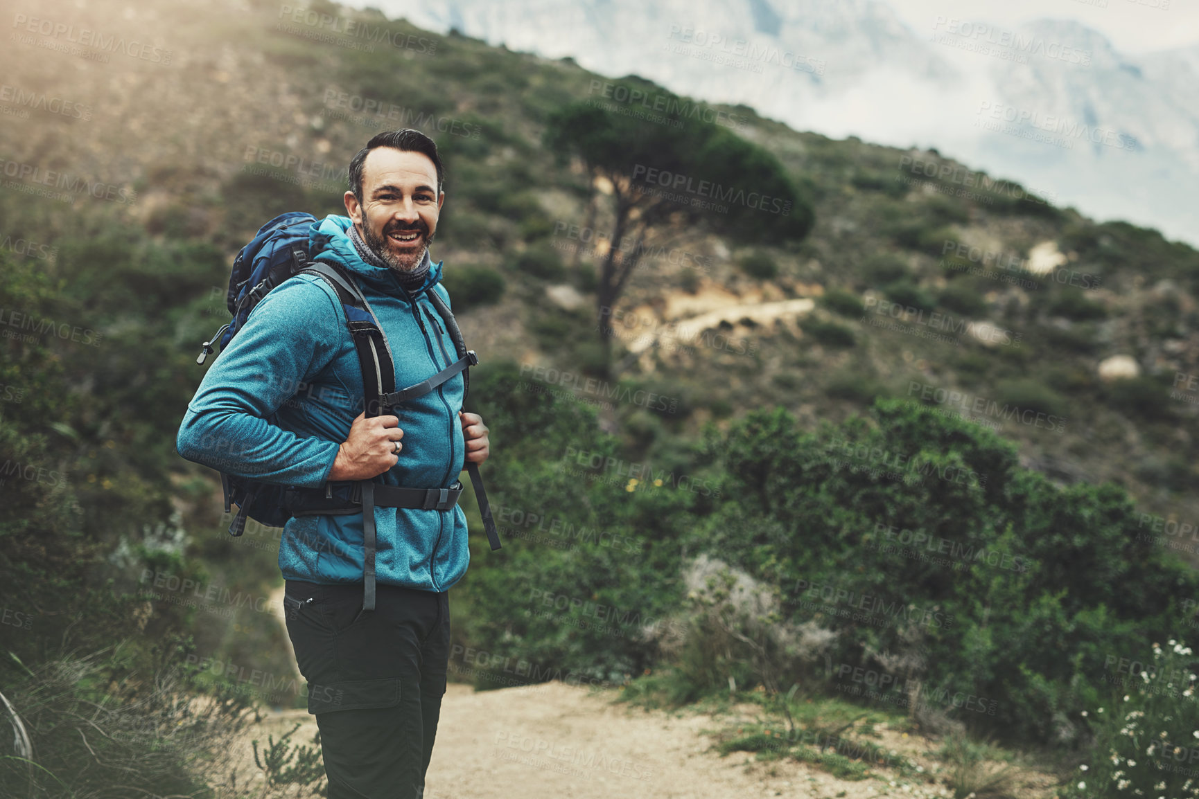 Buy stock photo Portrait of a middle aged man hiking in the mountains