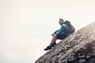 Buy stock photo Full length shot of a middle aged man sitting on the edge off a cliff