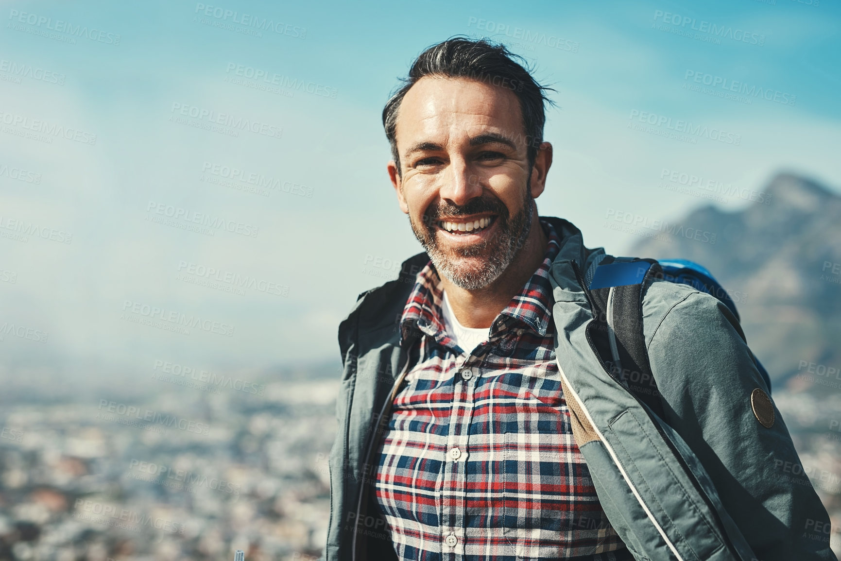 Buy stock photo Portrait of a middle aged man smiling in front of a mountain landscape