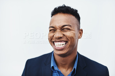 Buy stock photo Studio shot of a young businessman smiling and in good spirits against a grey background