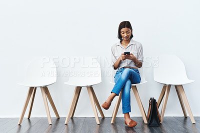 Buy stock photo Phone, social media and woman in interview waiting room and search the internet, web or website sitting on chairs. Internship, mockup and young female person texting online ready for a new job 