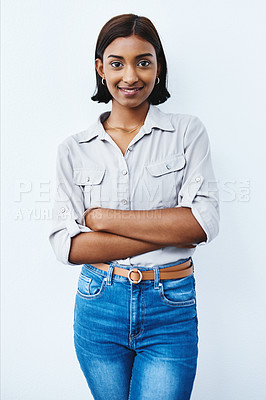 Buy stock photo Studio shot of a young creative businesswoman posing with her arms folded against a grey background