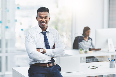 Buy stock photo Portrait of a young businessman standing in his office and posing with his arms crossed