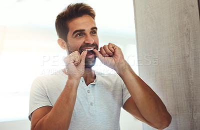 Buy stock photo Dental floss, teeth and mirror with man in bathroom for cleaning, morning routine and oral hygiene. Smile, cosmetics and health with male person flossing at home for self care, breath and mouth 