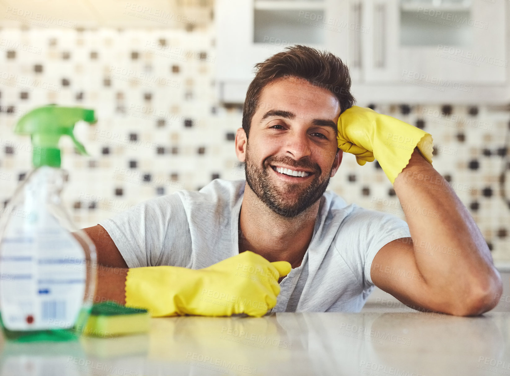 Buy stock photo Cropped portrait of a handsome young man cleaning his kitchen at home