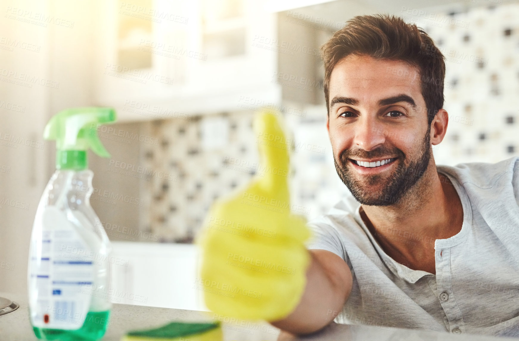 Buy stock photo Cleaning, thumbs up and portrait of happy man in home with gloves for hygiene, disinfection and washing. Housekeeping, housework and person with spray bottle for cleaner service, good job and success