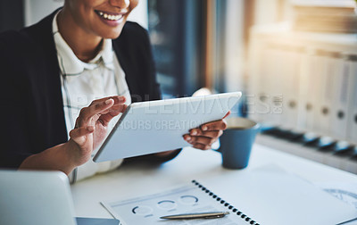 Buy stock photo Cropped shot of a young businesswoman using a digital tablet in a modern office