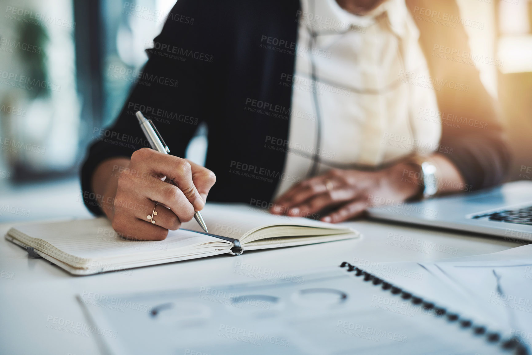 Buy stock photo Cropped shot of a businesswoman making notes at her desk in a modern office